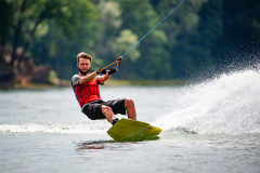 Wakeboarder surfing across a lake