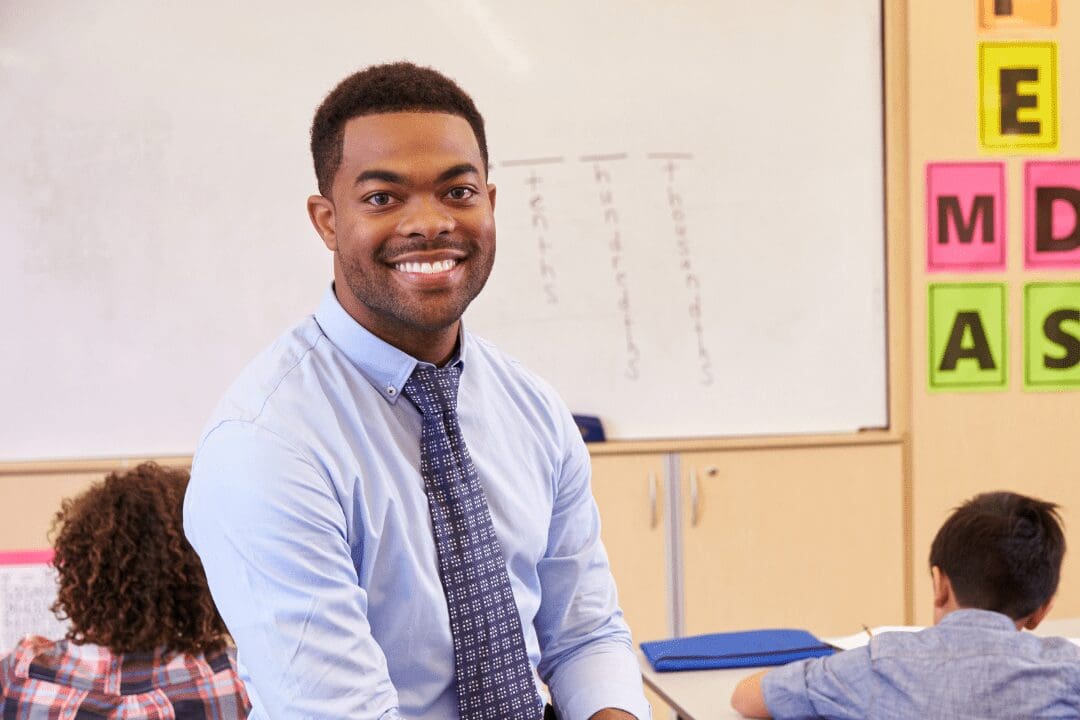African American Male M.A. in Education teacher with young students